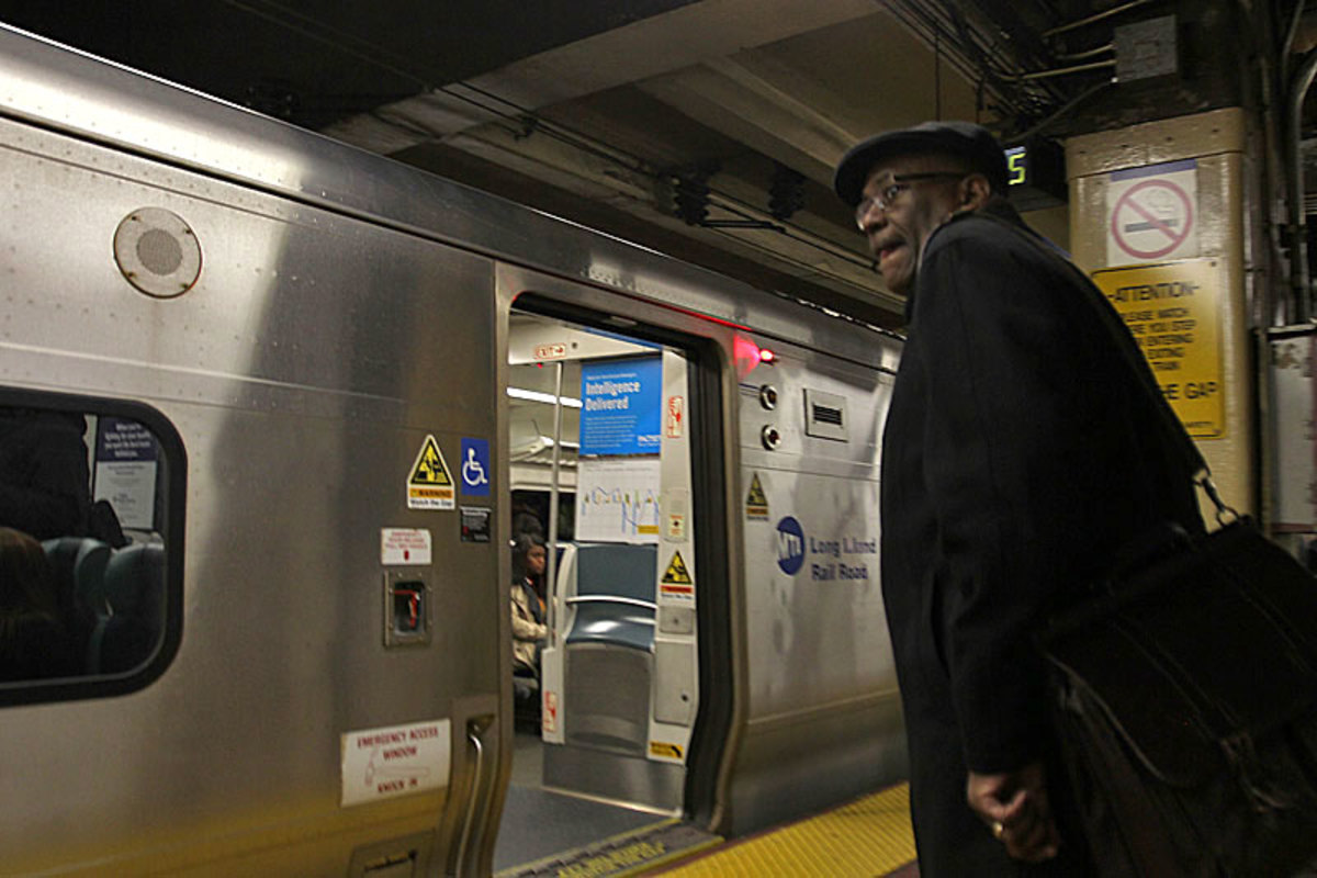 Wayne Mackie boards a commuter train headed home from his day job working on housing issues in New York City. He’s got Bears and Ravens video waiting for him.